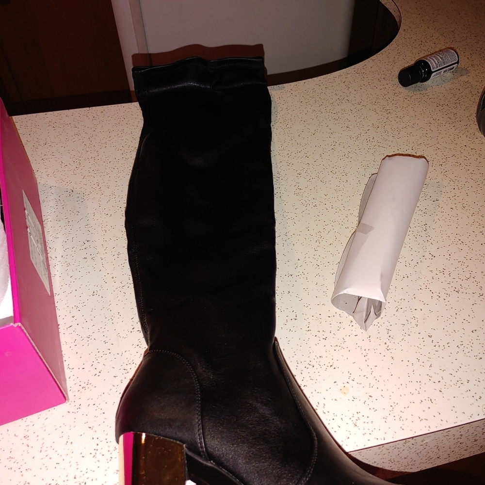 Woman's black leather above knee boots with gold h